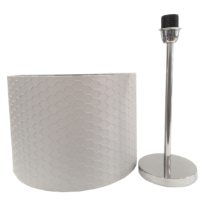 Table lamp with grey base and grey cylindrical lamp shade with relief