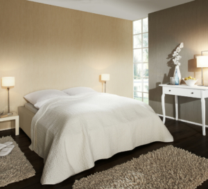 Bedroom with brown wallpaper, bed with white sheets, dressing table and bedside tables