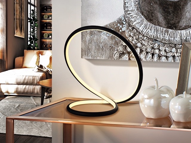 Infinity form lamp, colour black on a table