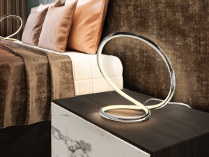 Infinity shaped table lamp with chrome finish on the table