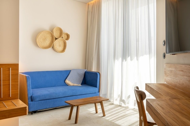 Bedroom with blue sofa, voile curtain with cream blackout